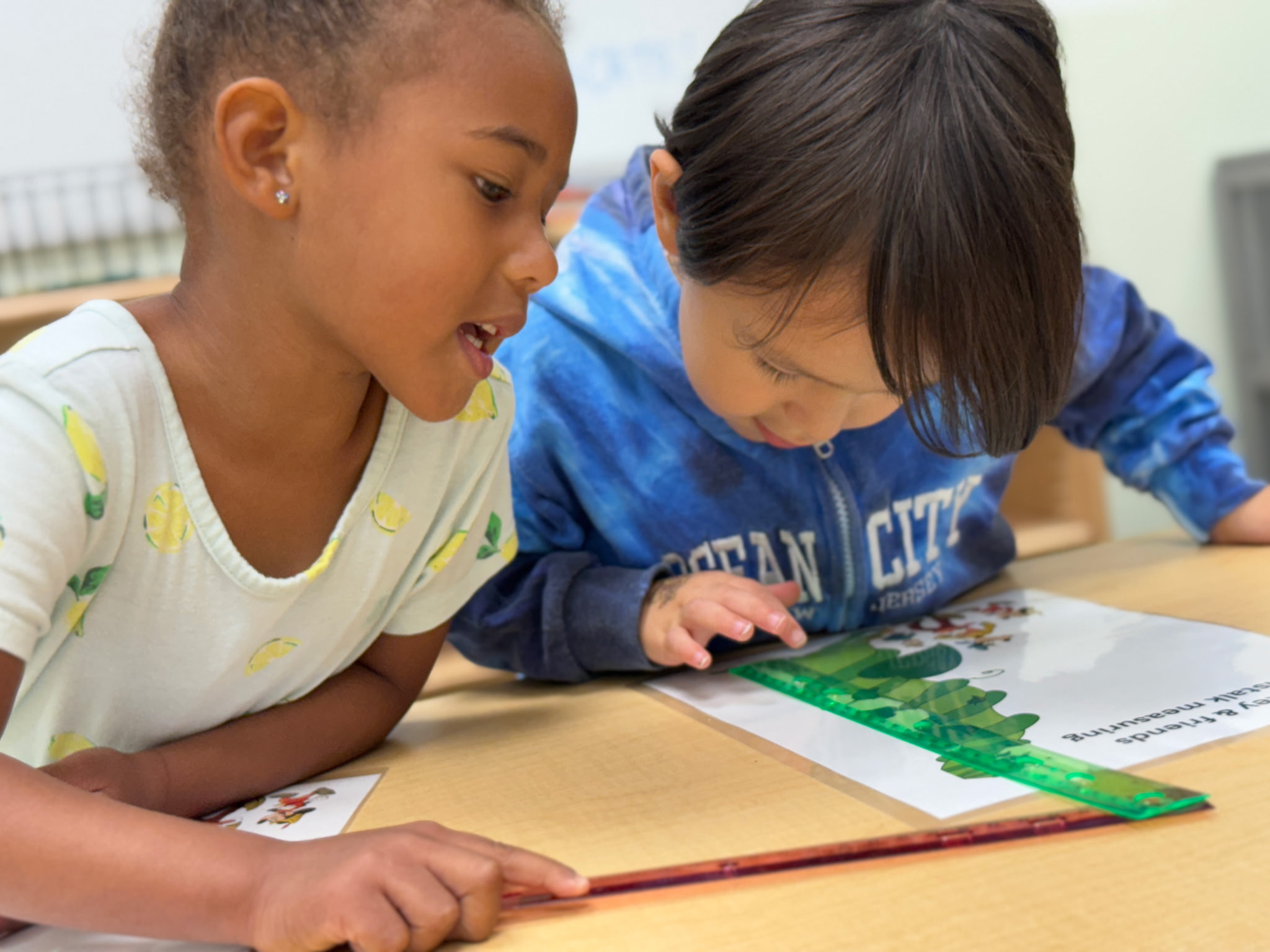 Two children working together on a reading activity